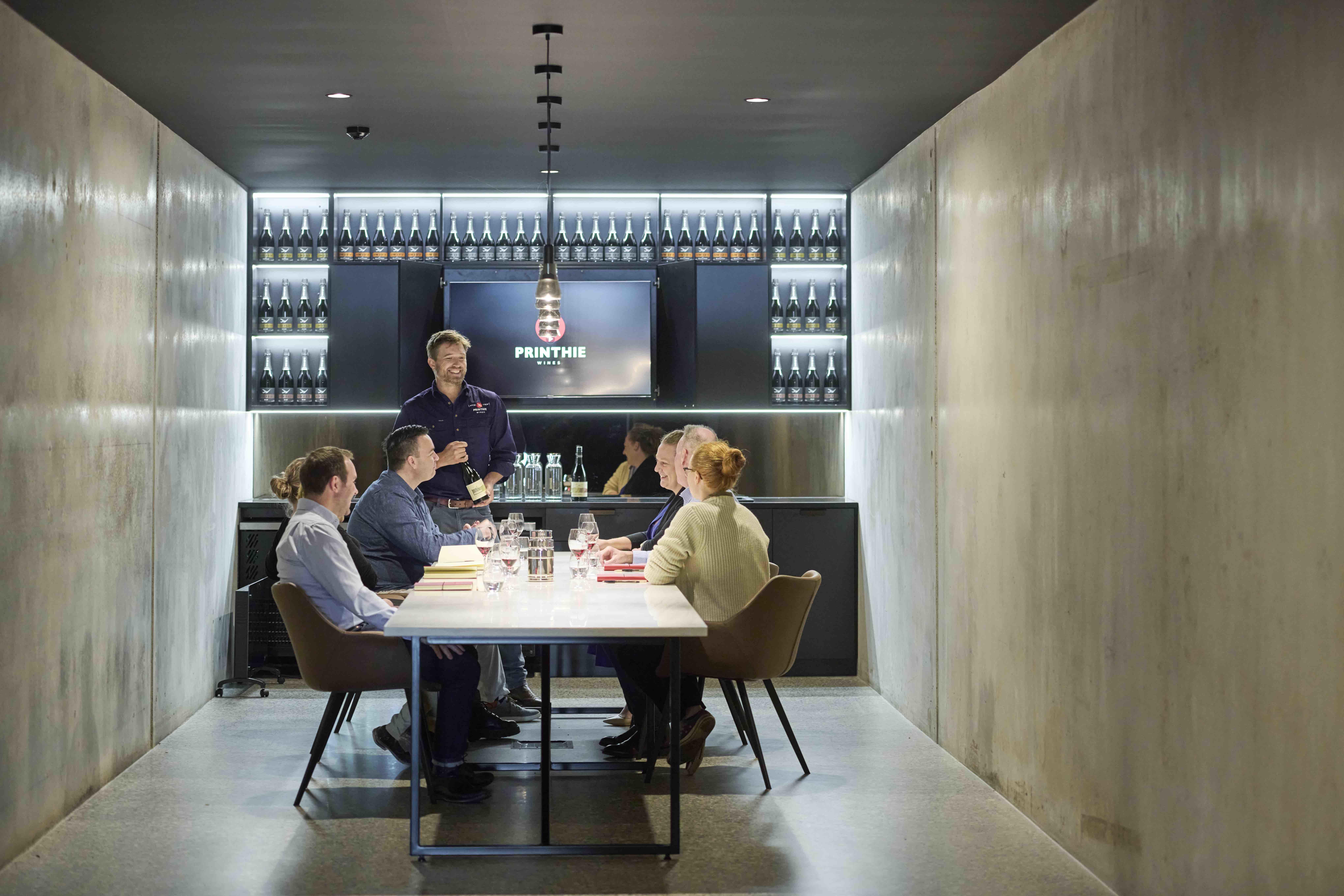 Image of group enjoying wine tasting in private conference room